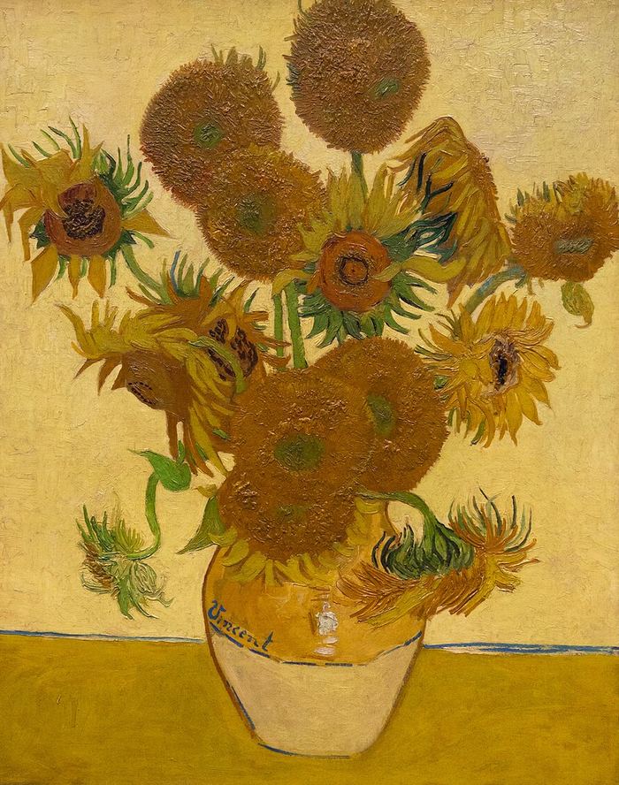 Oil painting of yellow sunflowers in a vase